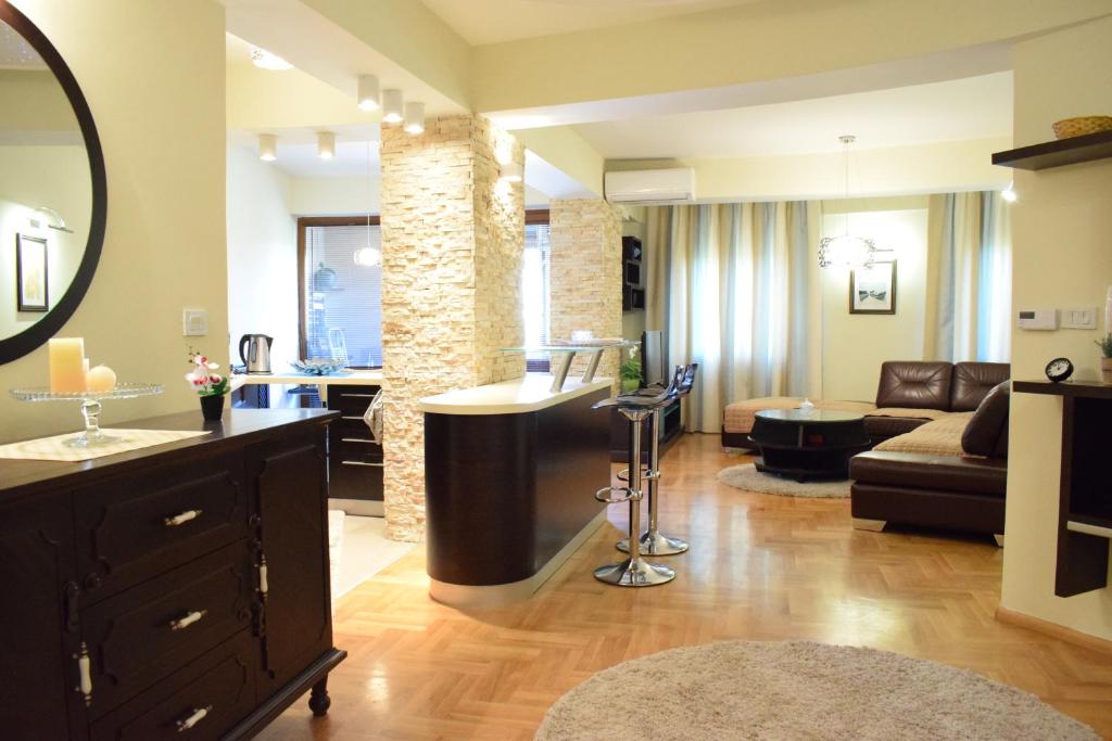 a living room with a bar in the middle of a room at Urban Vibe Apartments 2 in Skopje