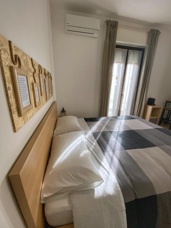 a bedroom with a large bed with a wooden frame at Il Giardino Segreto in Assisi