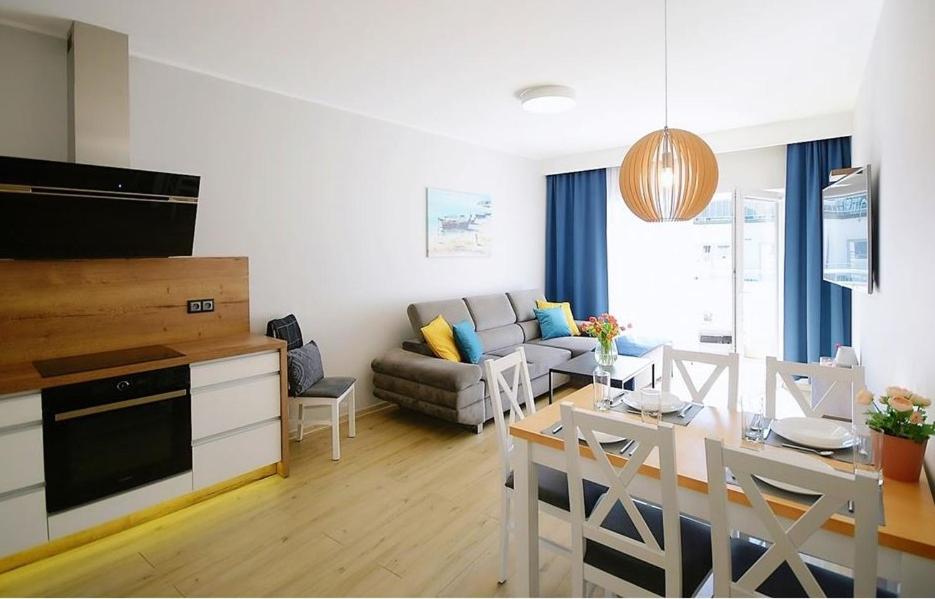 a kitchen and living room with a table and a dining room at Adrian Apartament in Herăstrău