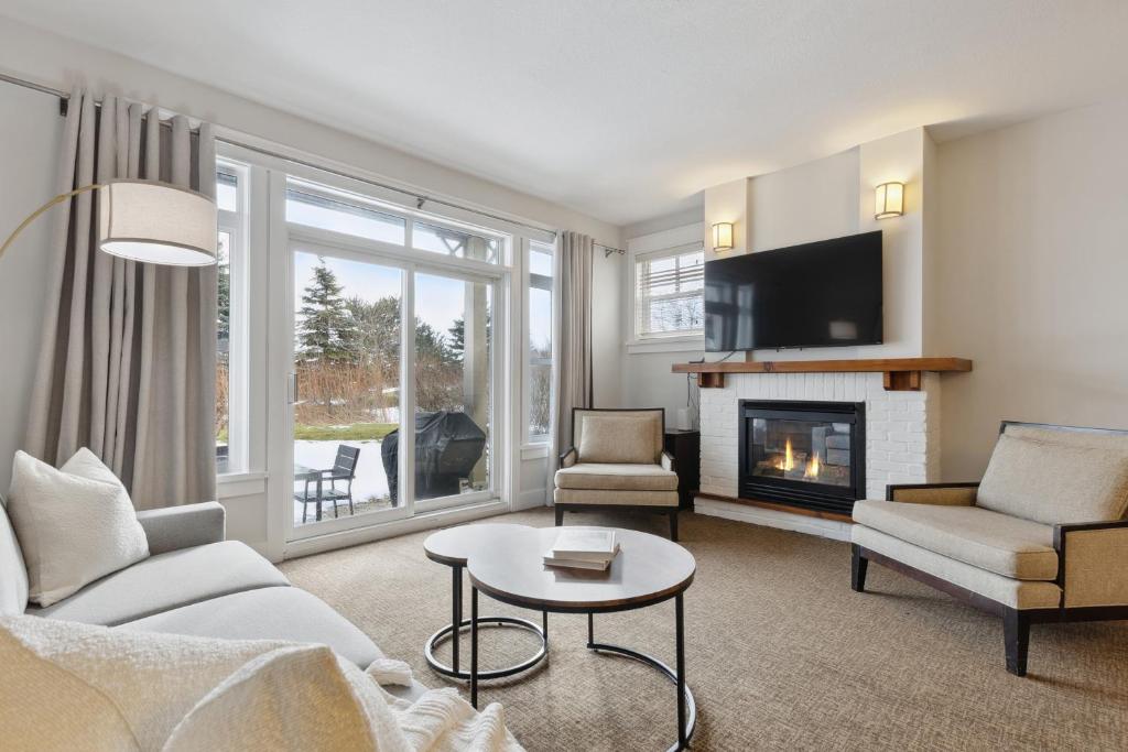 a living room with a couch and a fireplace at Blue Mountain Retreat at Rivergrass in Blue Mountains