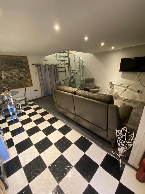 a living room with a couch and a checkered floor at Lovely 2 bed house in Hawkshead in Hawkshead