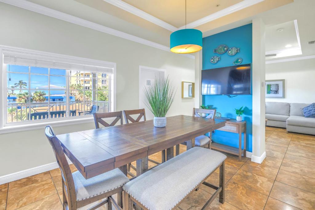 a dining room with a wooden table and chairs at New! Remodeled, Pool-Side, 1-min to Beach Path! in Siesta Key