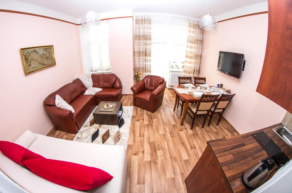 a living room with a couch and a table at Apartman Relax Olomouc in Olomouc