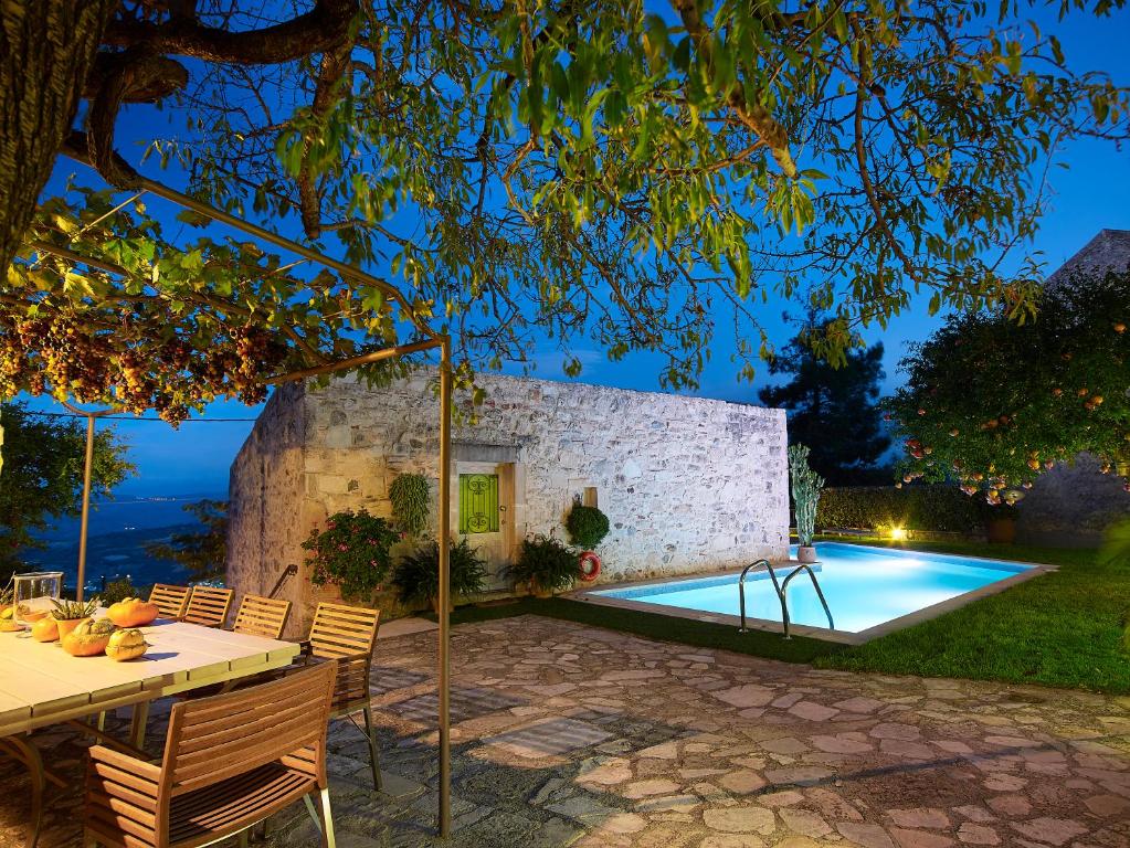 a villa with a swimming pool at night at Villa Kerasia in Vlakhianá