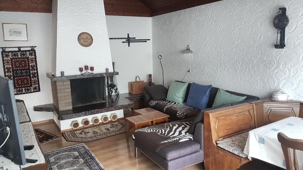 a living room with a couch and a fireplace at Apartment Birkenstrasse 54 Engelberg in Engelberg