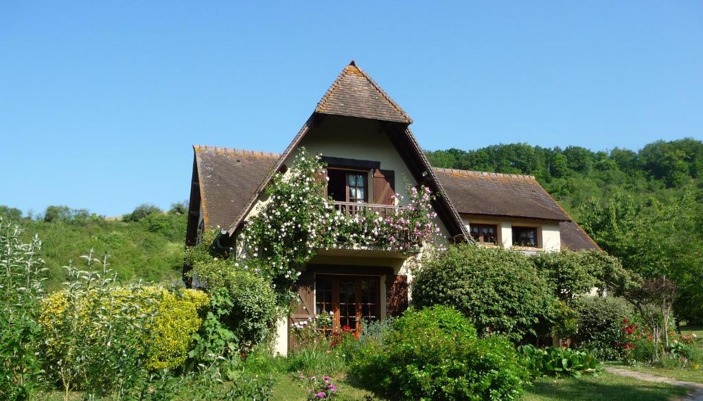 Une maison avec un bouquet de fleurs sur elle dans l'établissement Maison D'hôtes Les Coquelicots, à Giverny