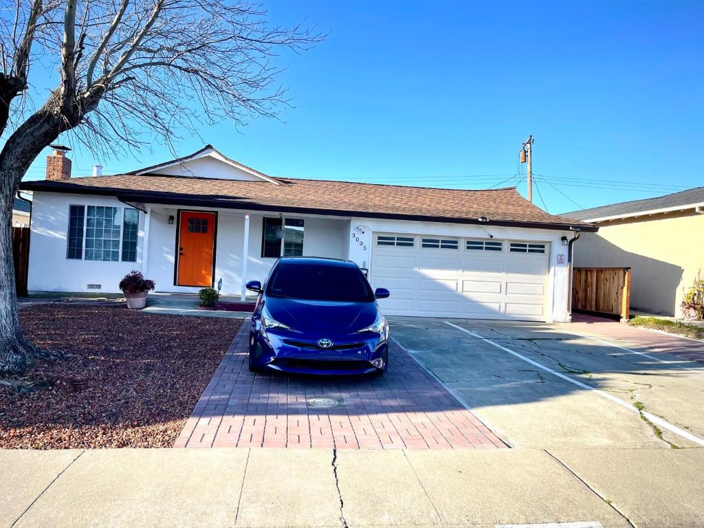 a blue car parked in front of a house at Cozy Home Silicon Valley ROOM 3 in San Jose