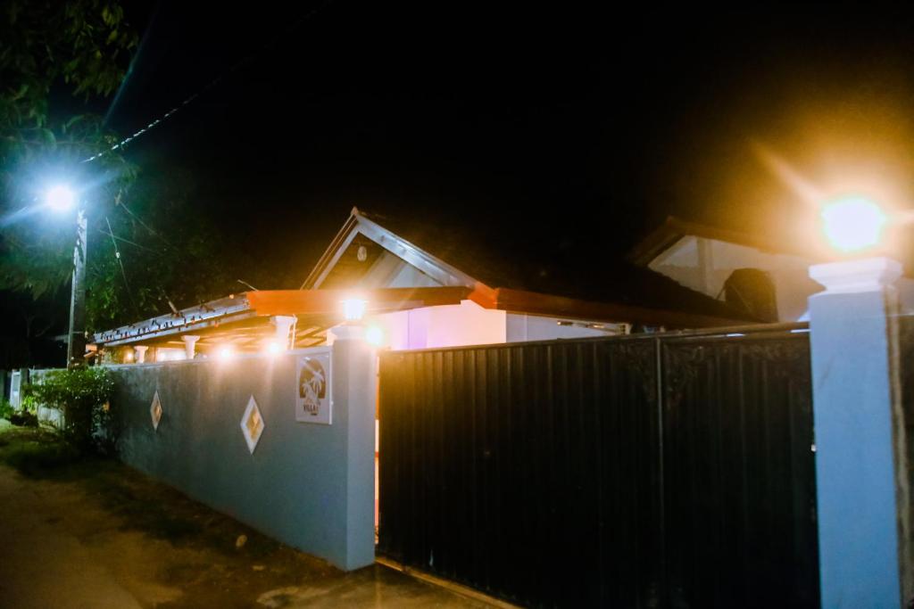 a house with lights on the side of it at night at Villa Number 6 in Weligama