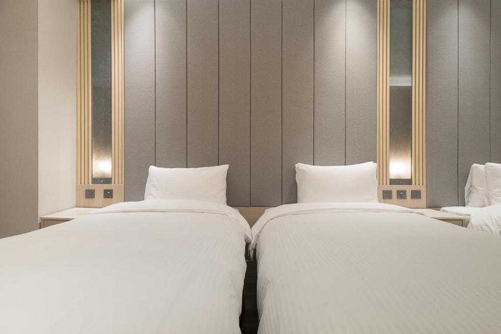 Postel nebo postele na pokoji v ubytování Gamalan Breeze Hotel