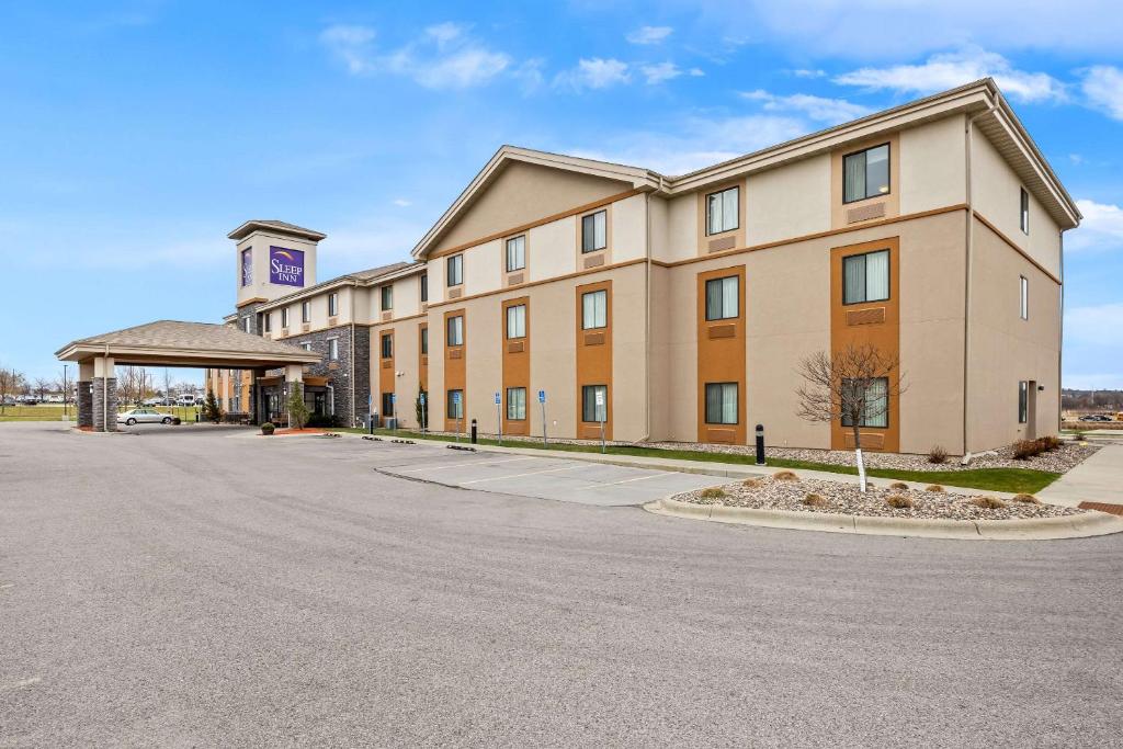 a large building with a road in front of it at Sleep Inn & Suites West-Near Medical Center in Rochester
