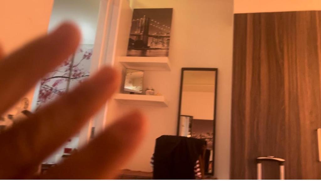 a close up of a persons hand in front of a mirror at Doc Azenith Presidential Suite - Horizon Nica Condos in Cebu City
