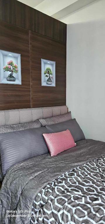 a bedroom with a large bed with two pictures on the wall at Relaxing Chic Hotel Like with Manila Bay view in Manila
