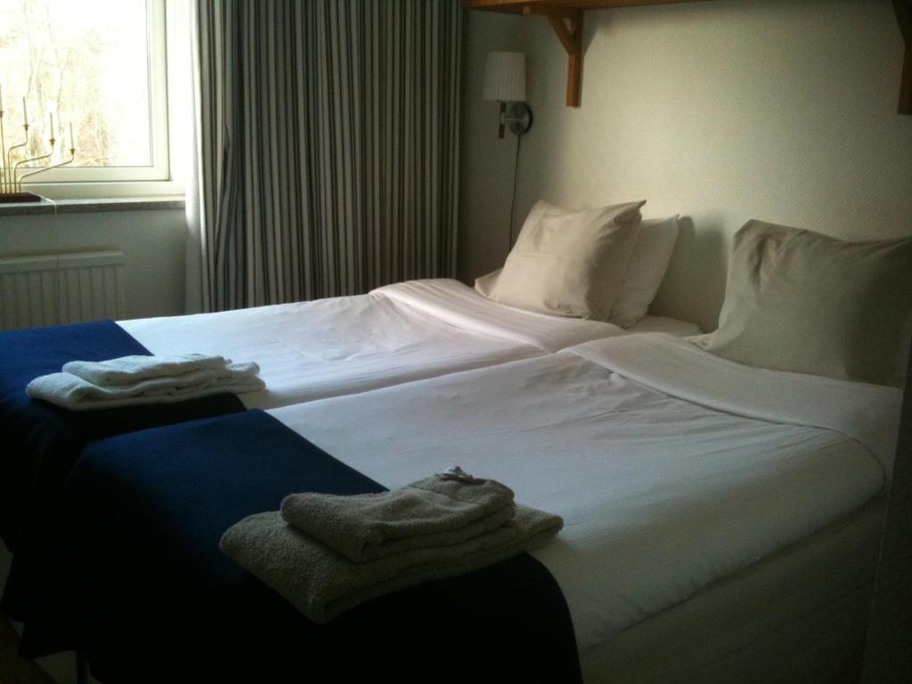 Postel nebo postele na pokoji v ubytování Kiviks Hotell