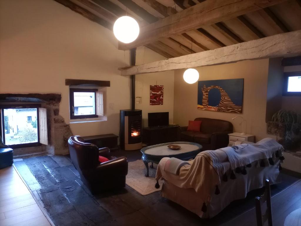 ein Wohnzimmer mit Sofa und Tisch in der Unterkunft GOIKO ETXE Refugio Rural in Urdiáin