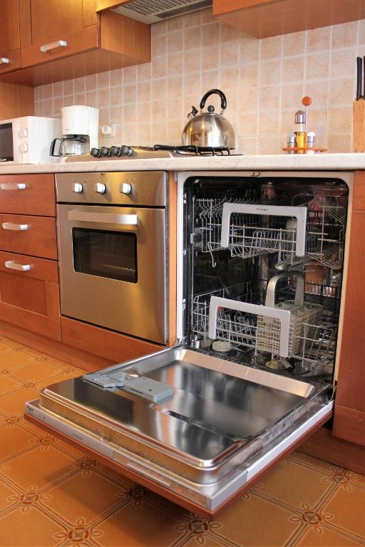 an oven with dishes inside of it in a kitchen at Discover Italy in Tignes