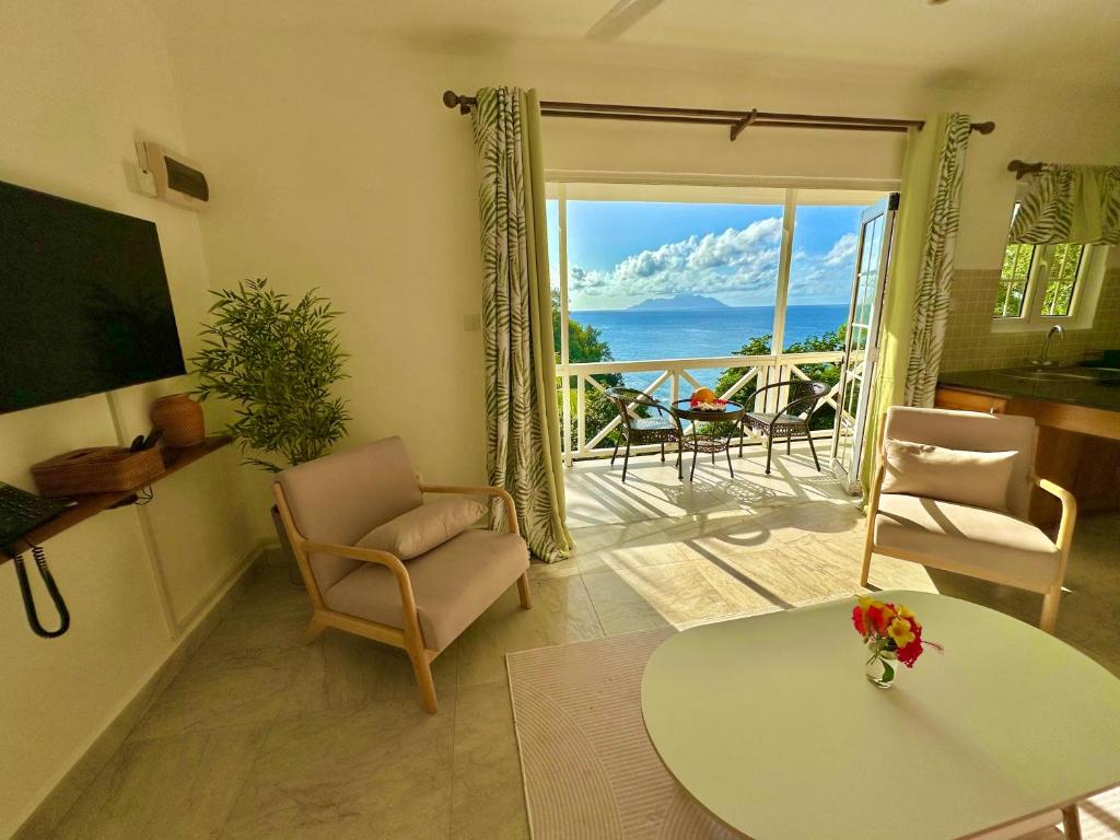 a living room with a view of the ocean at Spas Villas La Villa in Victoria