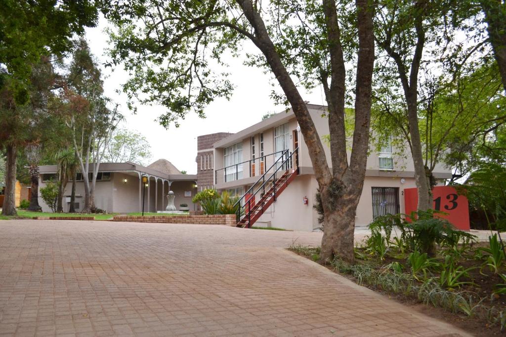 a house with a brick driveway in front of it at B at Home Guest House in Piet Retief