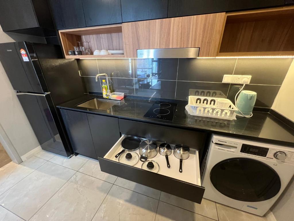 a small kitchen with a stove and a dishwasher at AXON RESIDENCE BUKIT BINTANG KL CITY View in Kuala Lumpur
