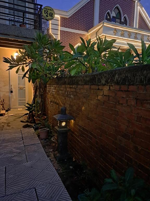 a fire hydrant with a light on the side of a brick wall at 包棟Linsen Secret Realm 27 in Tainan