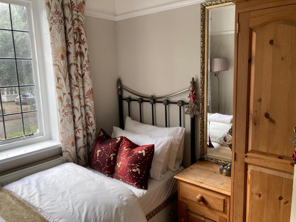 a bedroom with a bed and a mirror at The mole hole in Kent