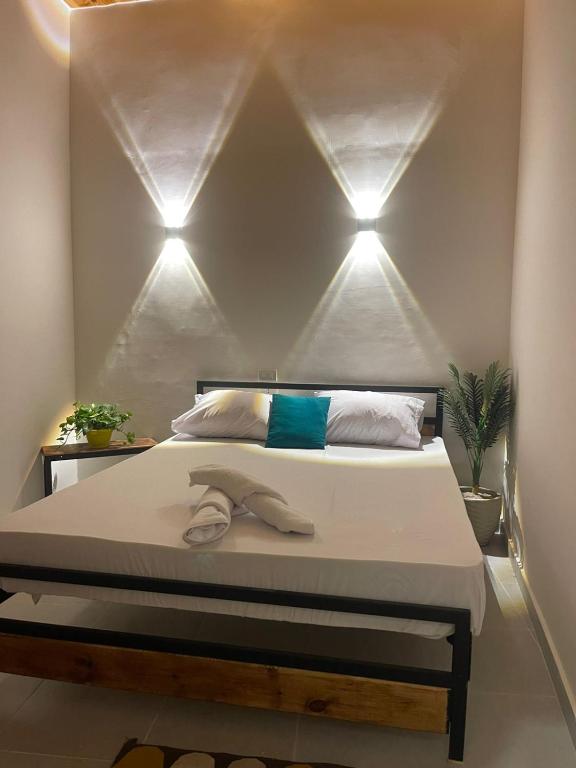 a bedroom with a bed with three lights on it at Tota house in dahab in Dahab