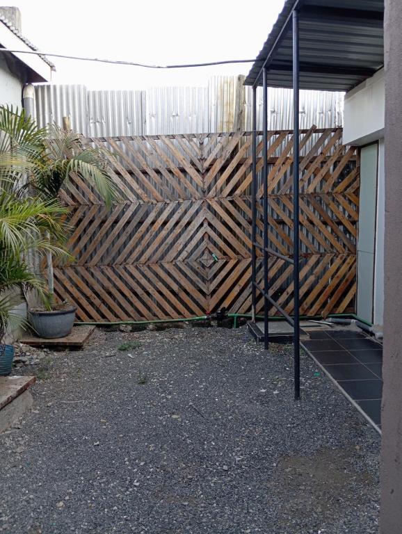 a wooden fence in front of a building at Traven Homes - 1BR Unit in Nairobi