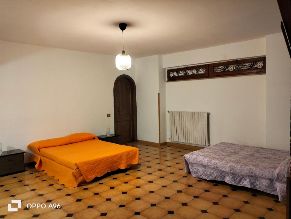 Postel nebo postele na pokoji v ubytování Al focolare di Enzo