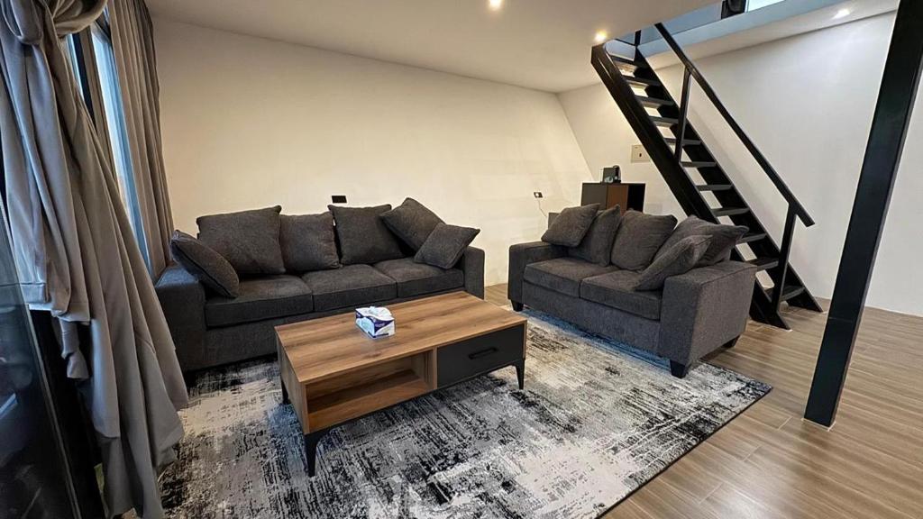 a living room with two couches and a coffee table at Moon Light Camp in Bidiyah