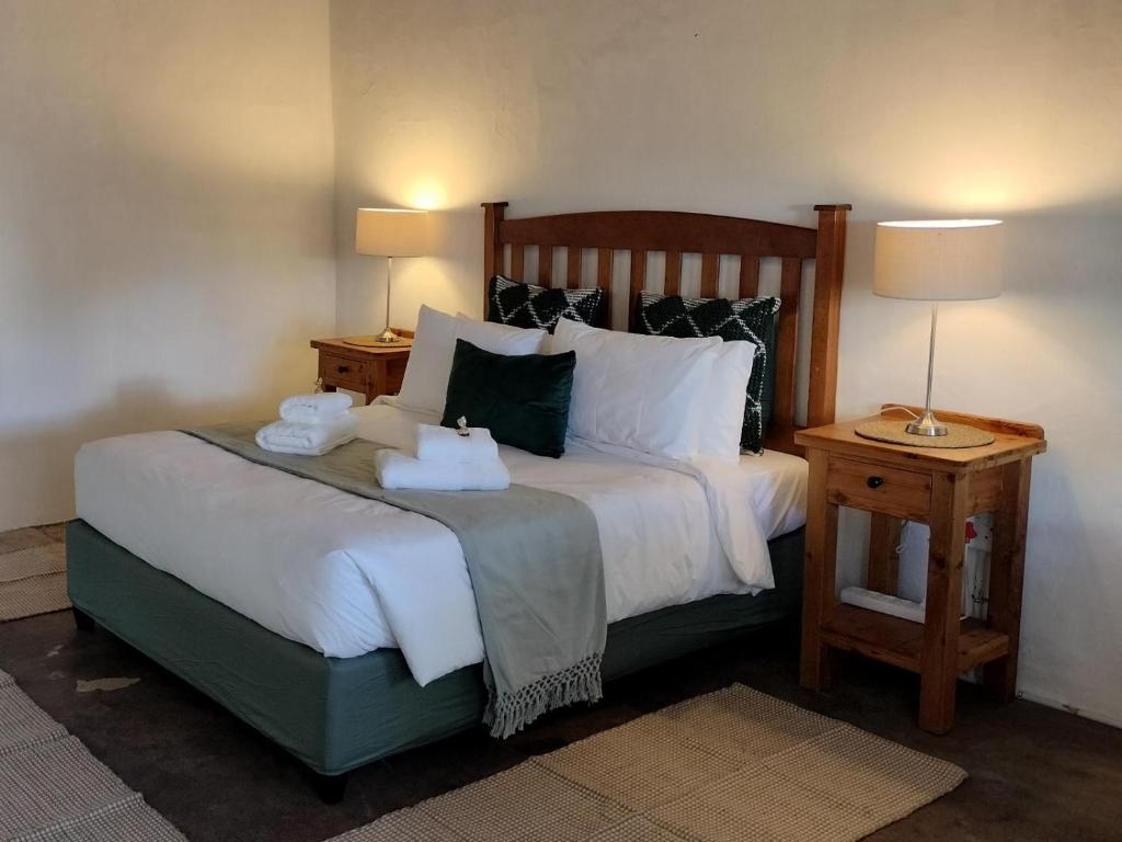a bedroom with a bed with two towels on it at Rusgenot - Richmond, Karoo in Richmond