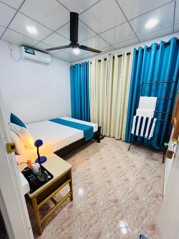 a small room with a bed and a table at Ranga's House in Weligama