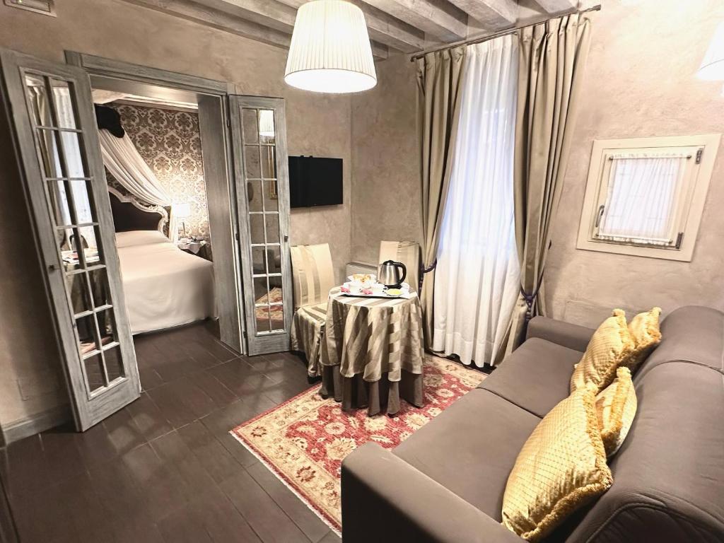 a living room with a couch and a table at Hotel Antiche Figure in Venice