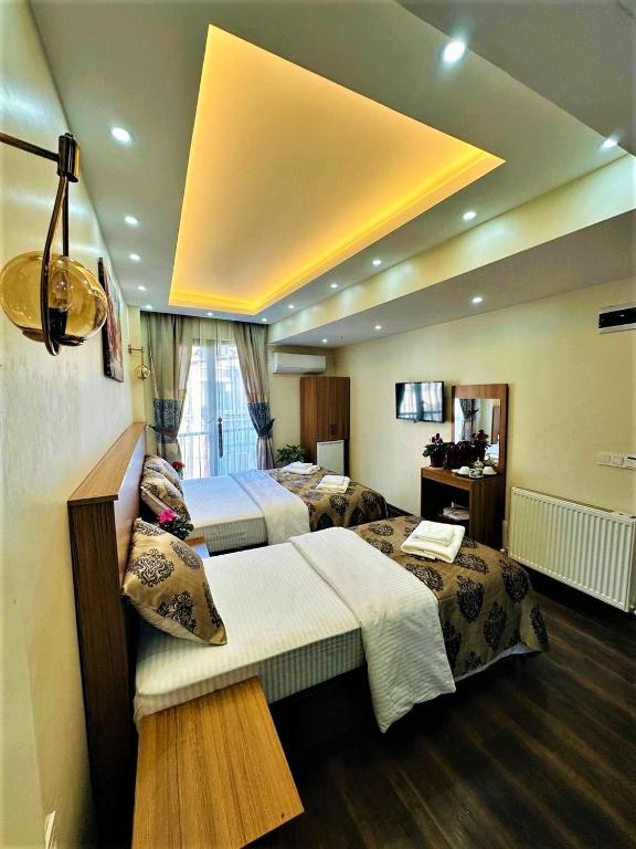 Postel nebo postele na pokoji v ubytování Hotel By Historia