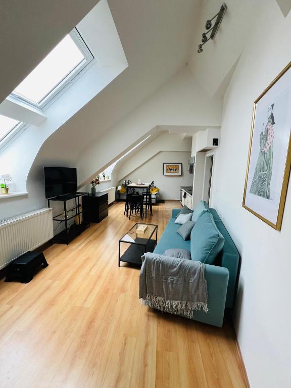 Hotel Central, Cozy & Stylish Apartment with Views, a living room with a blue couch and a table at Central, Cozy & Stylish Apartment with Views in Prague