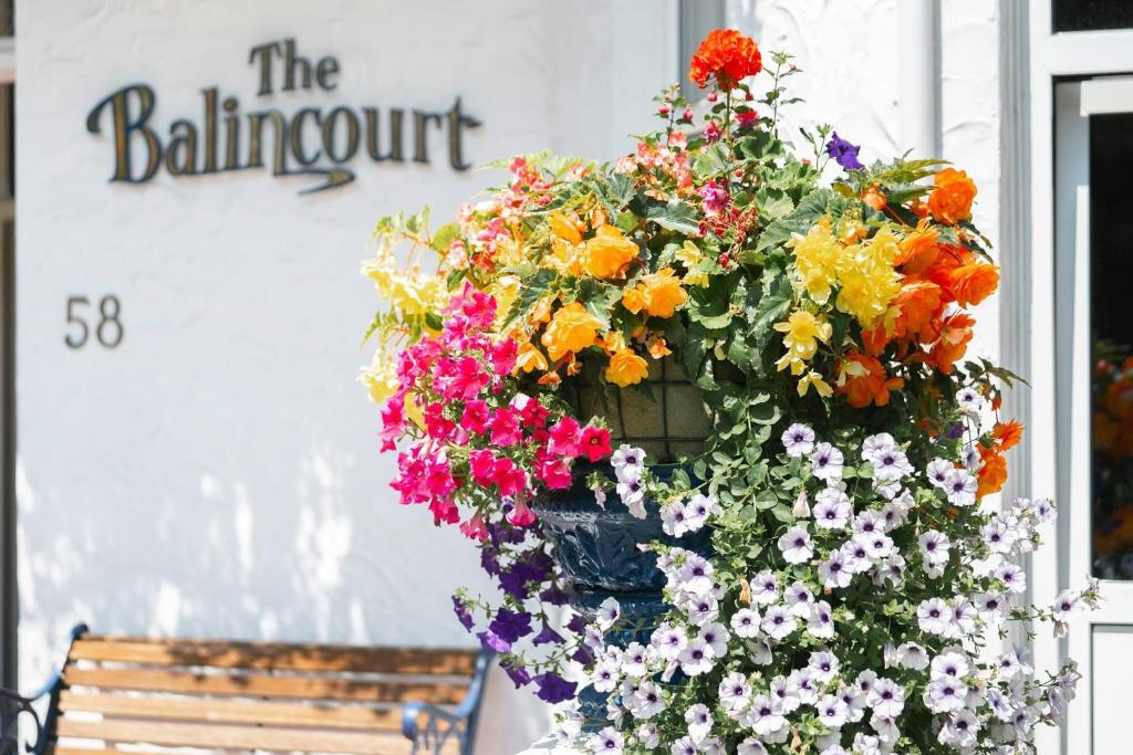 a hanging basket of flowers in front of a building at Balincourt in Bournemouth