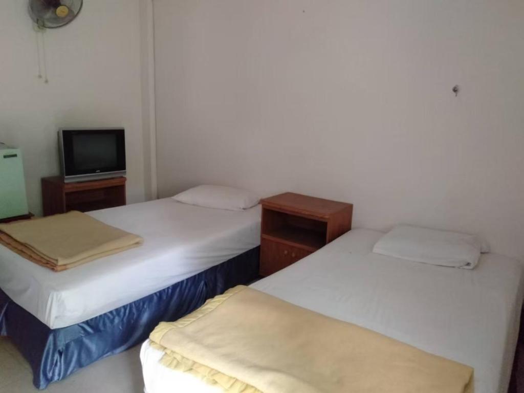 Postel nebo postele na pokoji v ubytování Sawadee Place Maehongsorn Hotel near city