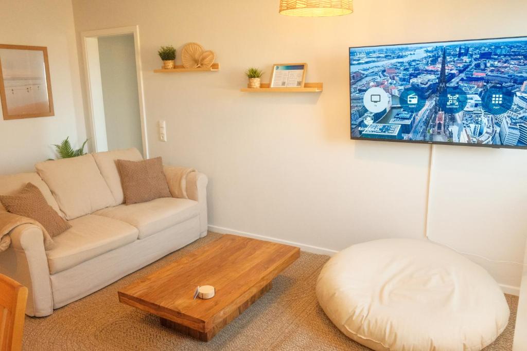 TV a/nebo společenská místnost v ubytování Seestern Strandträume - 5 min zu Fuß zum Strand