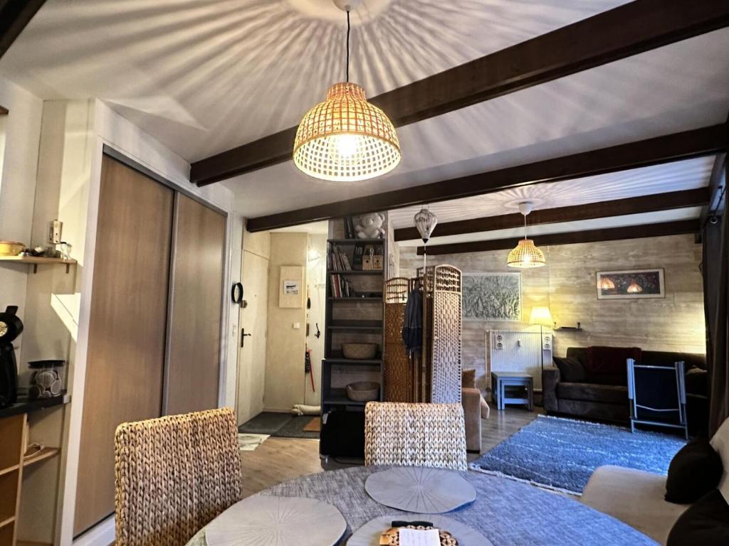 a living room with a table and chairs and a couch at Résidence Bero Bisto - maeva Home - Appartement 2 Pièces 6 personnes - Confort MAE-0191 in La Mongie