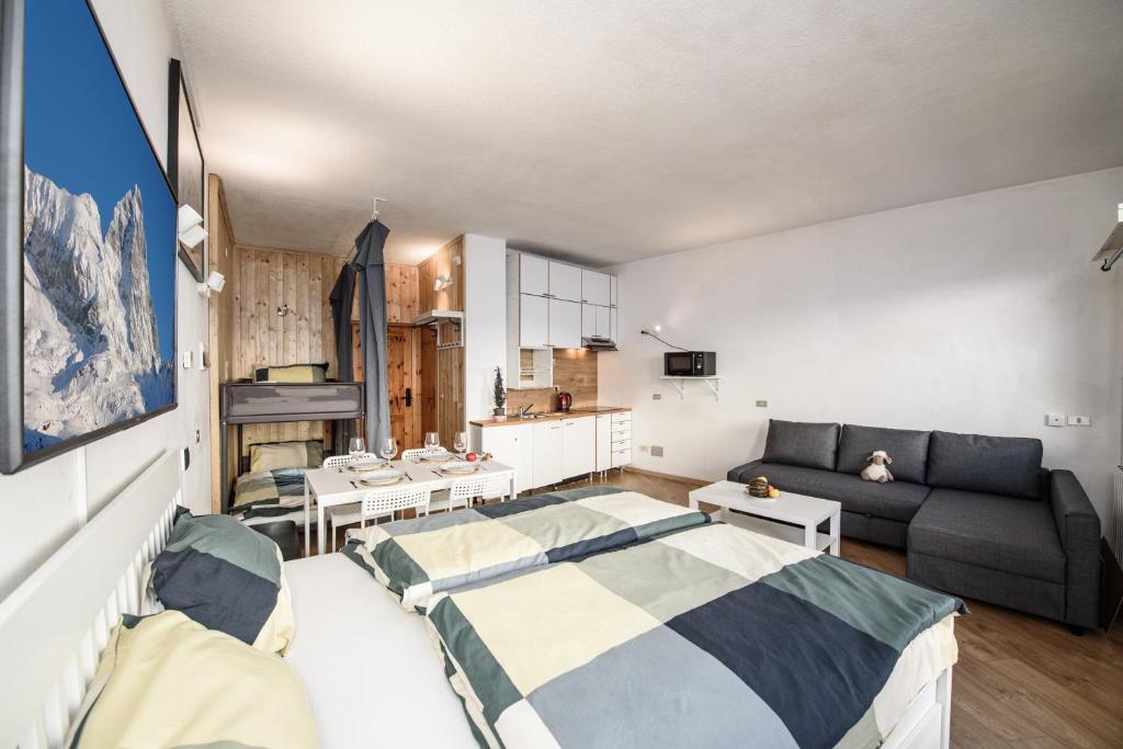 a living room with two beds and a couch at Erikzang - Cervinia Ski in Ski out Apartments in Breuil-Cervinia