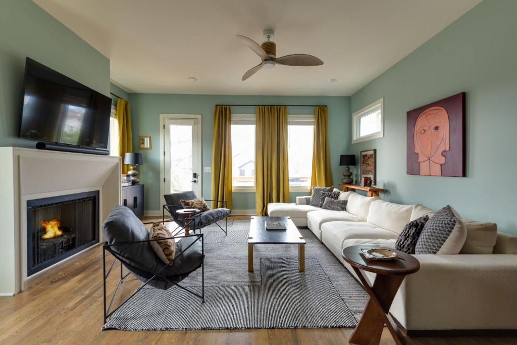 a living room with a couch and a fireplace at The Lyric - New Luxury Home, Rooftop with Firepit! in Nashville