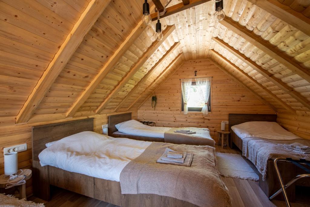 a room with three beds in a log cabin at Kuća za odmor Franka in Skenderovci