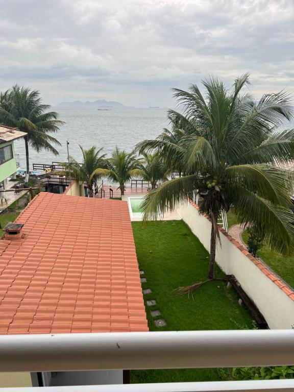 a view of the ocean from the balcony of a building at Casa para temporada com vista para o Mar in Mangaratiba