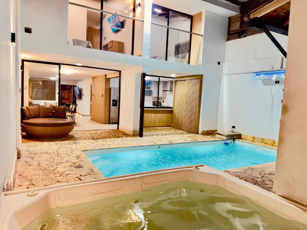 a large swimming pool in the middle of a house at Casa Provenza in Medellín