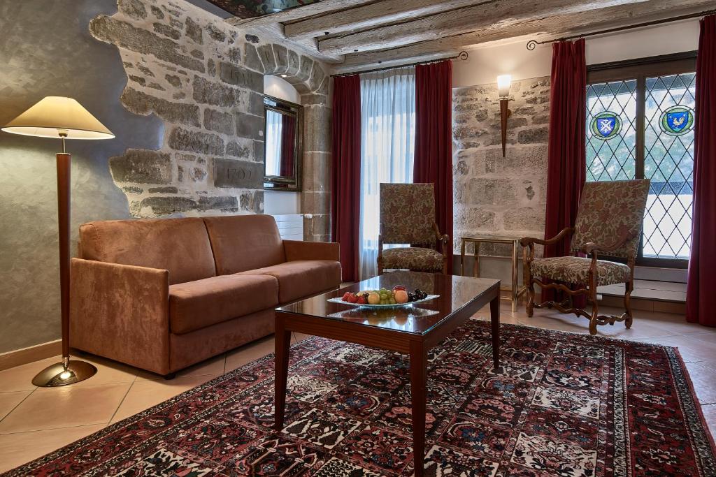 a living room with a couch and a table at Hotel d'Allèves in Geneva