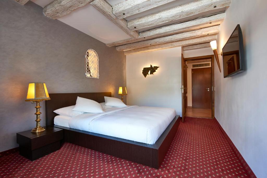 a bedroom with a large white bed in a room at Hotel d'Allèves in Geneva