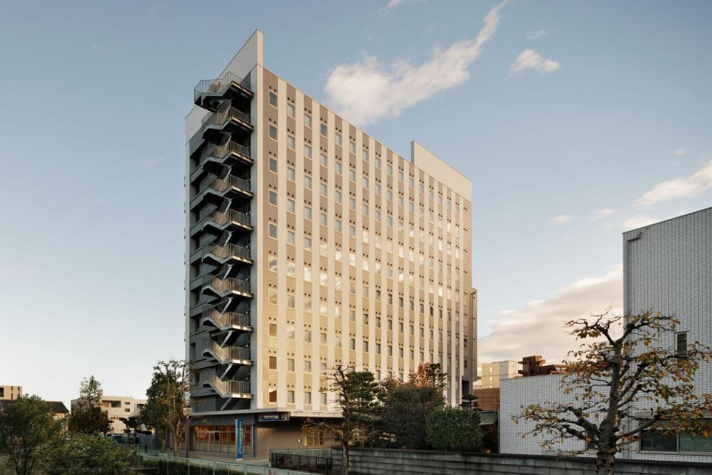 a tall building in the middle of a city at Four Points Flex by Sheraton Utsunomiya in Utsunomiya