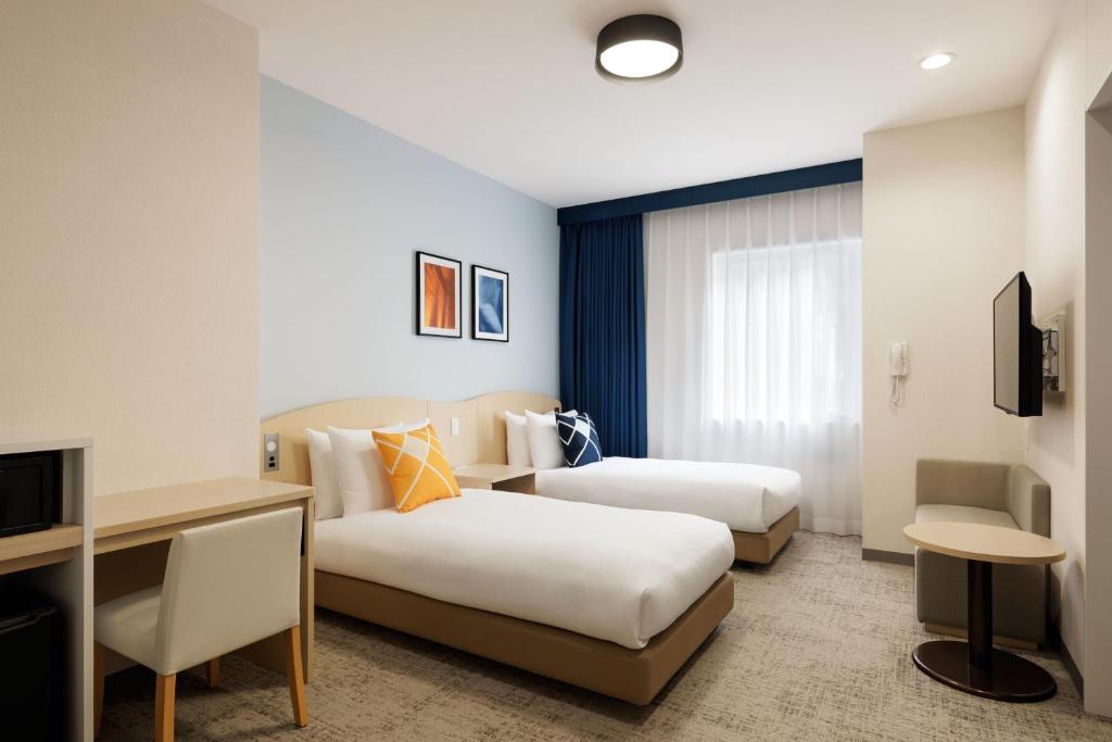 Postel nebo postele na pokoji v ubytování Four Points Flex by Sheraton Utsunomiya