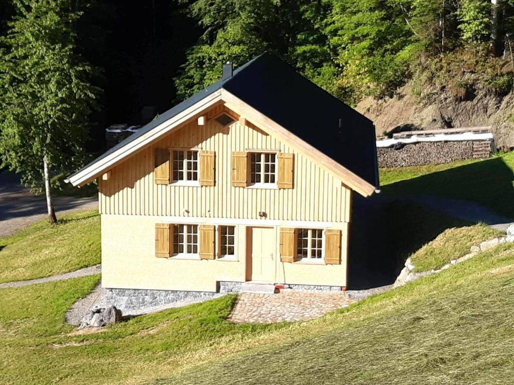 a small house on top of a hill at Reich in Bizau