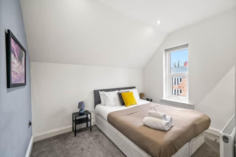 a white bedroom with a bed with a window at BridgeCity Entire apartment 1Bedroom Apartment Free Parking in Kent