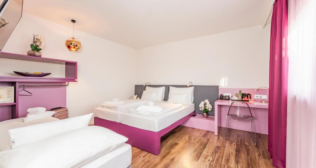 Cama o camas de una habitación en PLAZA INN Graz