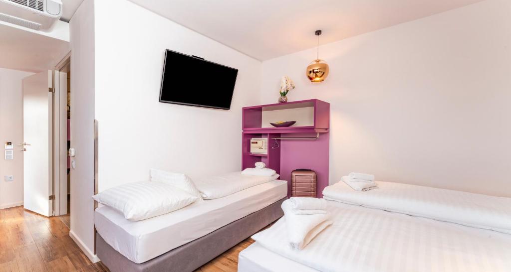 Cama o camas de una habitación en PLAZA INN Graz